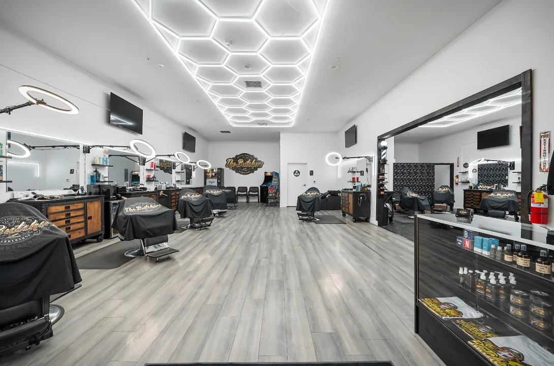 Row of styling stations with ring lights and mirrors