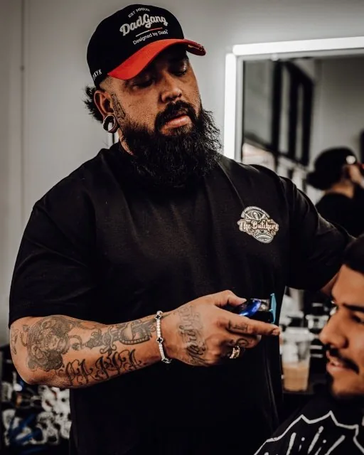Rudy G. — manager at The Butchers Barbershop French Valley — working on a cut